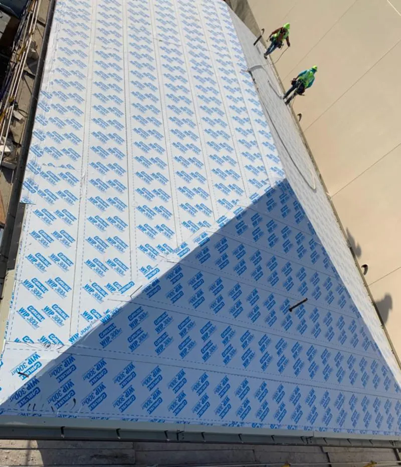 Professional roofers installing underlayment on a metal roof in El Cajon